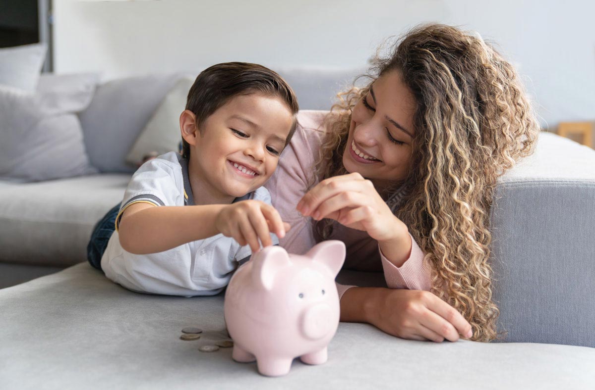 Mother and son using piggybank